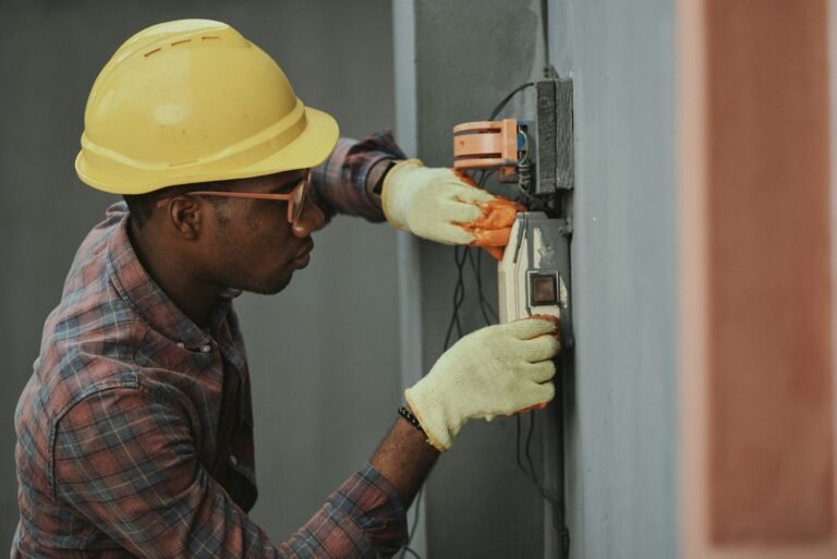 Licensed electrician inspecting a home electrical panel in the UAE
