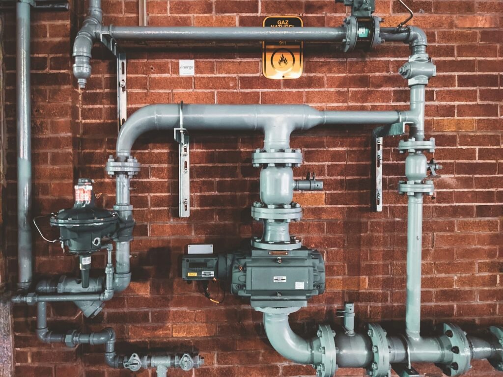 Exposed water supply pipes and valves in a UAE home